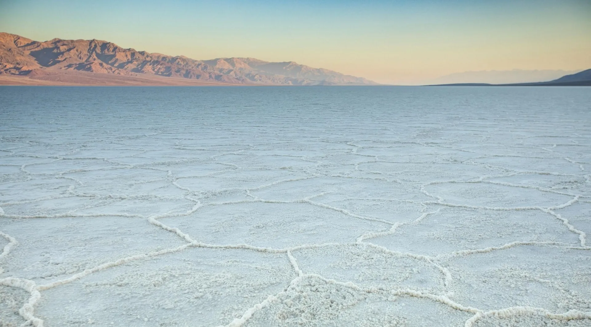 Salt flats stretching toward distant mountains