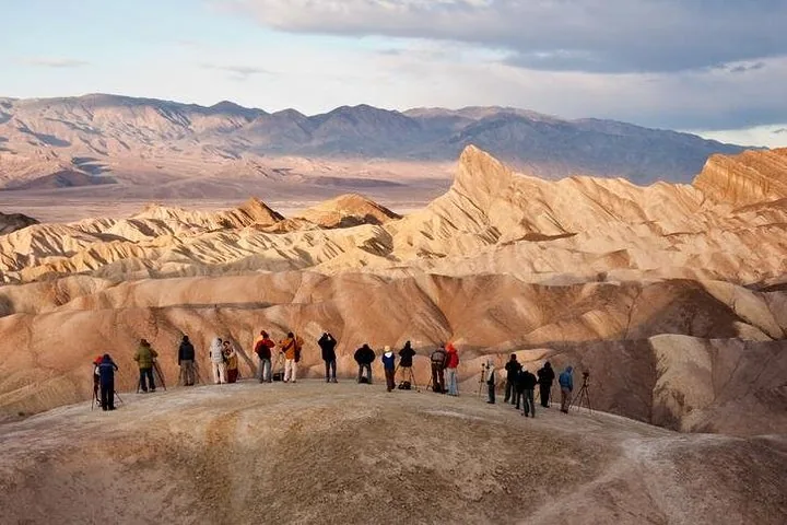 Visitors framed by a desert canyon