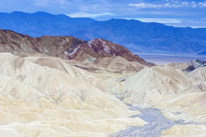 Pale hills edged by distant mountains